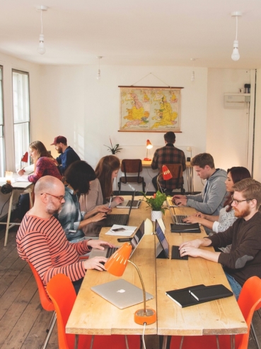 Inside the ARK coworking space, workers gathered around tables with laptops